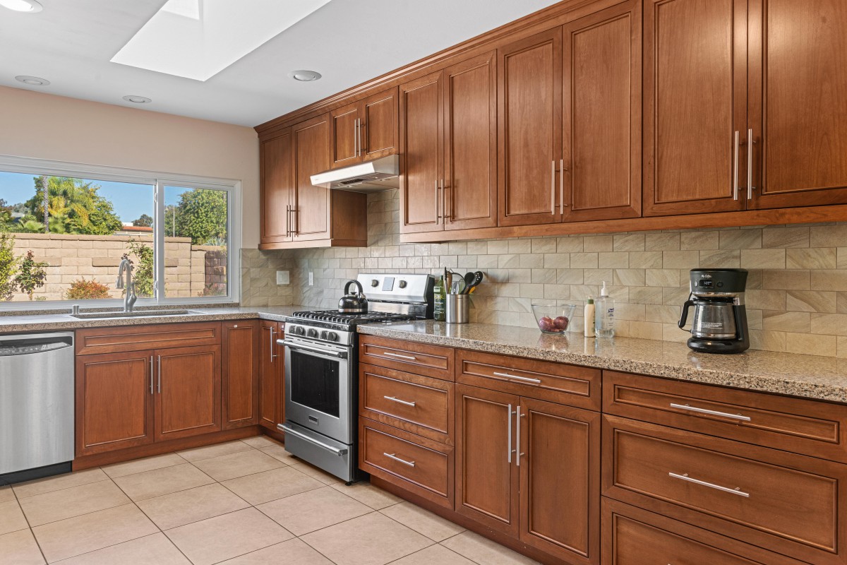 A modern kitchen with wooden cabinets and stainless steel appliances.