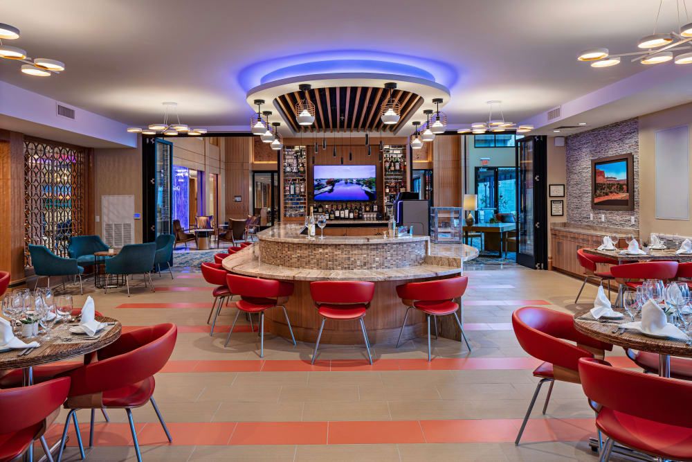 A modern lounge bar with vibrant lighting and stylish seating arrangements.