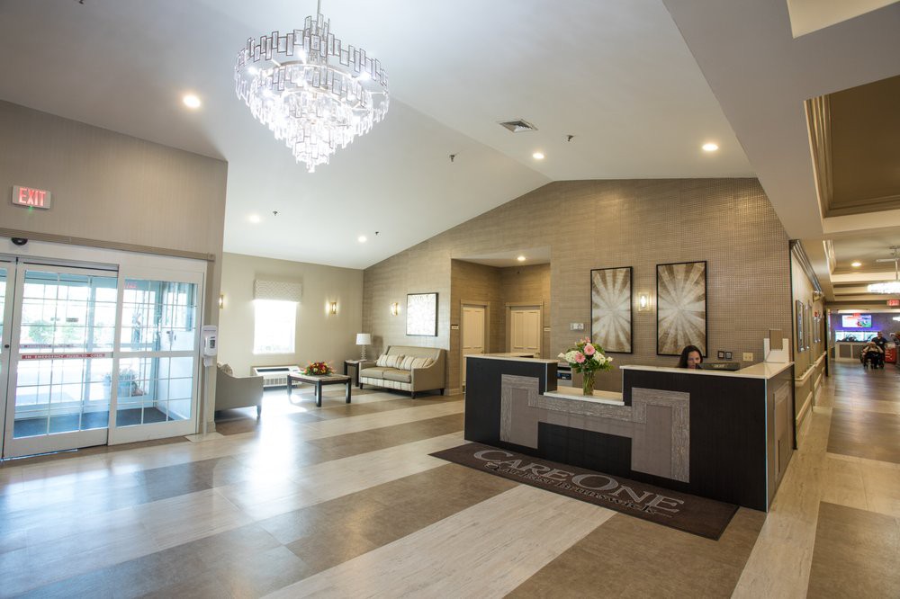 A modern lobby with a chandelier and a welcoming reception area.