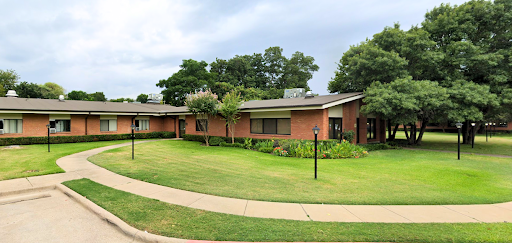 A picturesque view of a modern residential house surrounded by a lush green lawn.