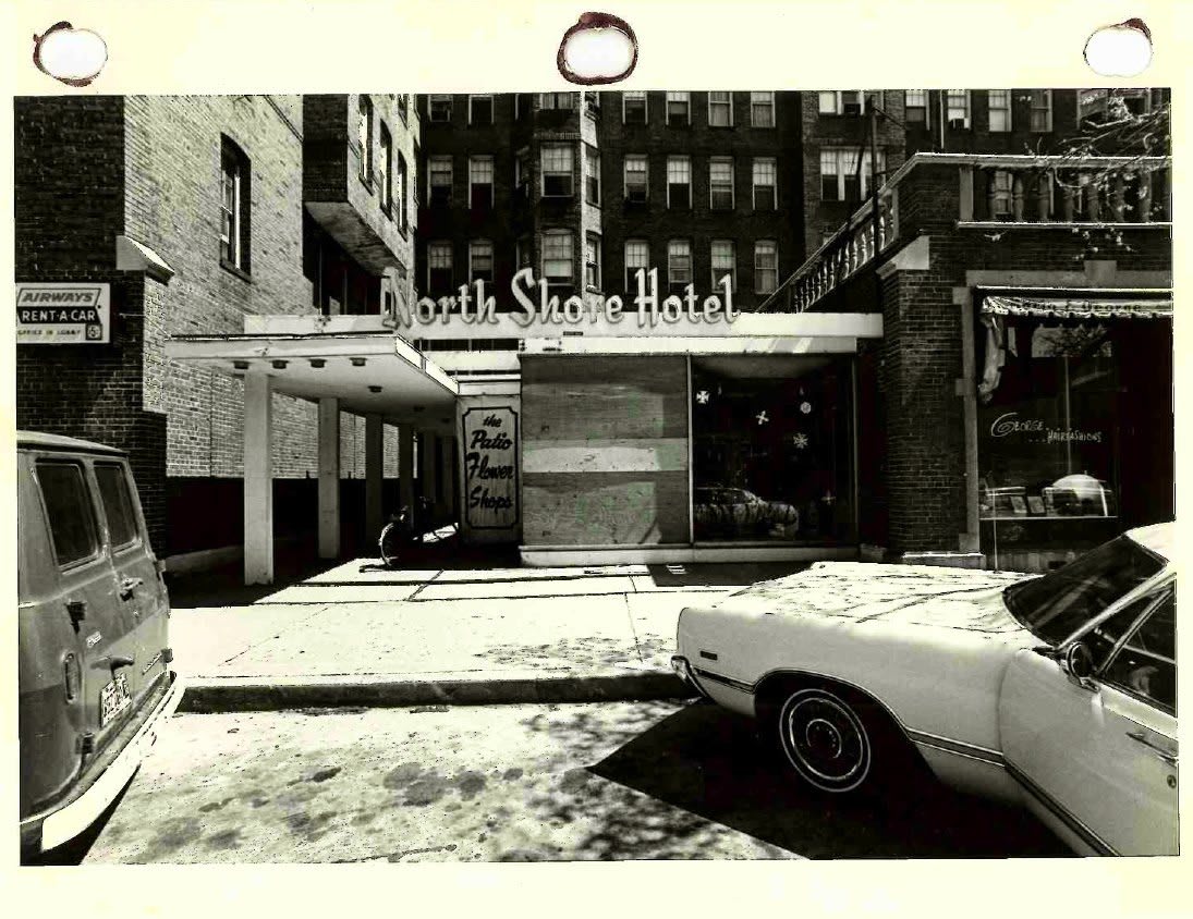 A vintage black and white photo of the Park Slope Hotel with classic cars on the street.