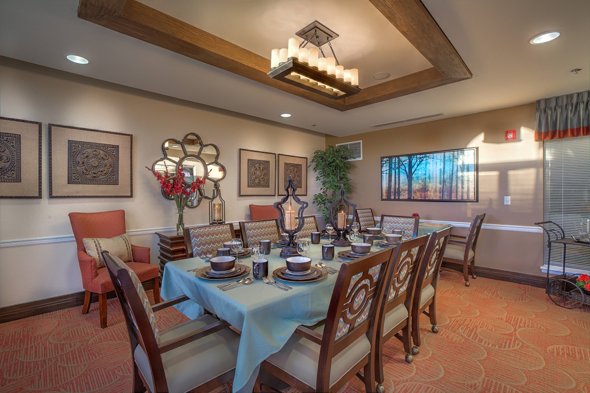 An elegantly designed dining room with a beautifully set table and stylish decor.