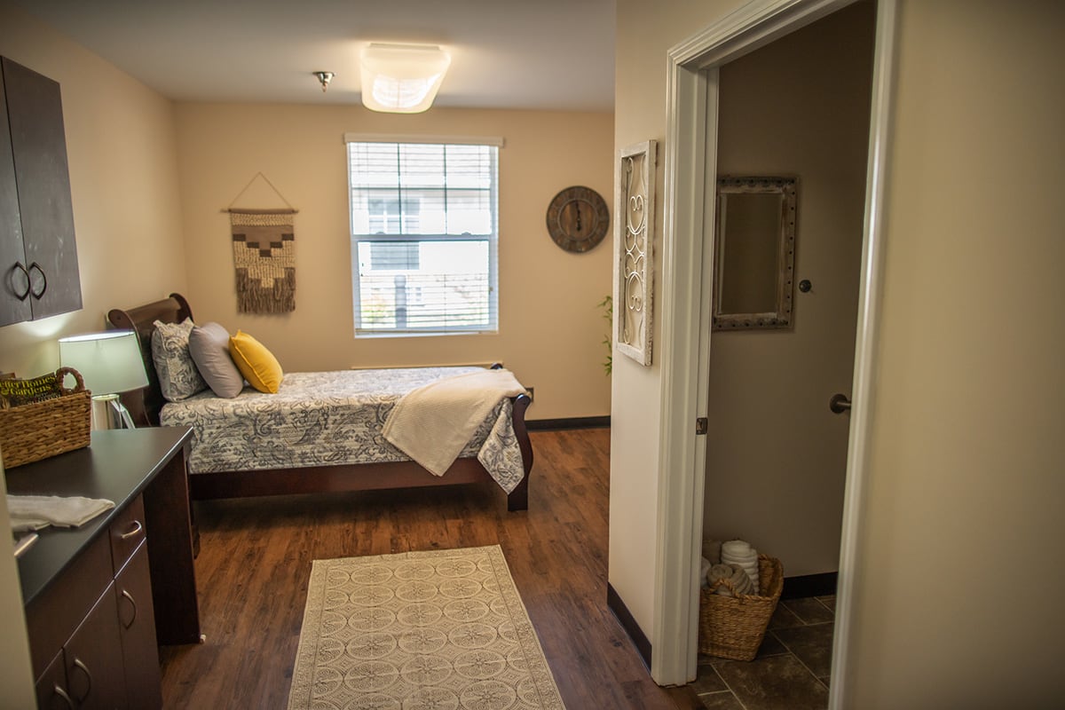 A cozy bedroom with warm decor and natural lighting.