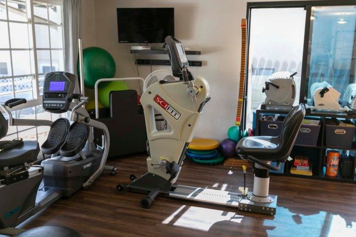 A well-equipped gym featuring various exercise machines and fitness tools.