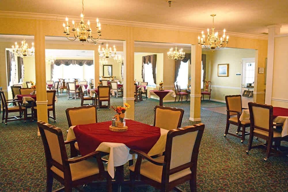 An elegant dining room with chandeliers and well-arranged tables.