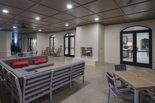 A modern living room featuring a spacious seating area with a fireplace, contemporary furniture, and stylish decor.