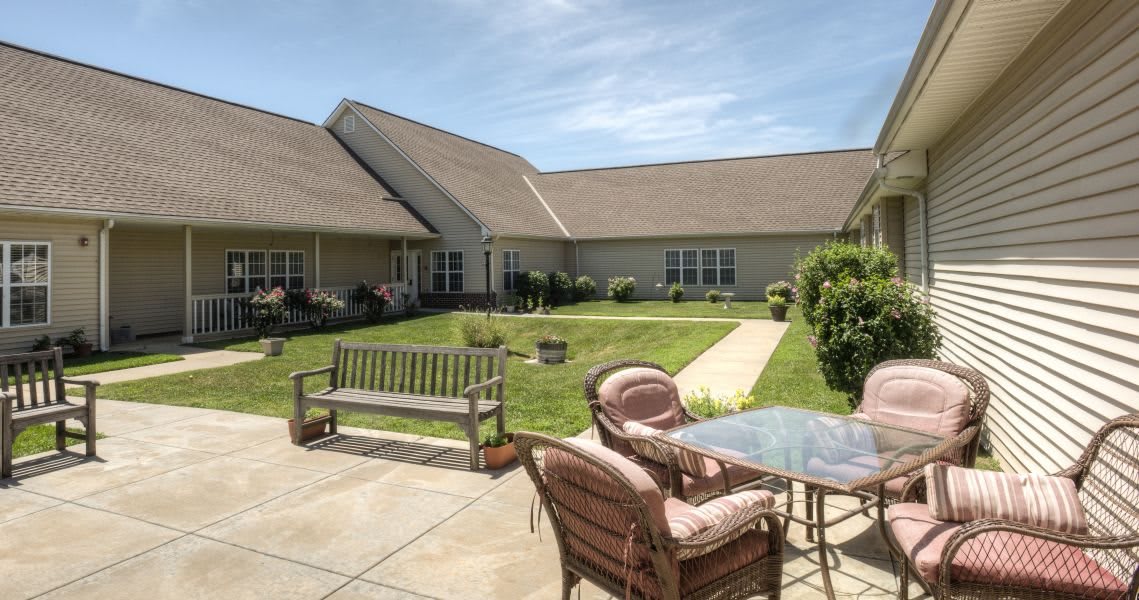 A peaceful courtyard with outdoor seating and a well-maintained garden.