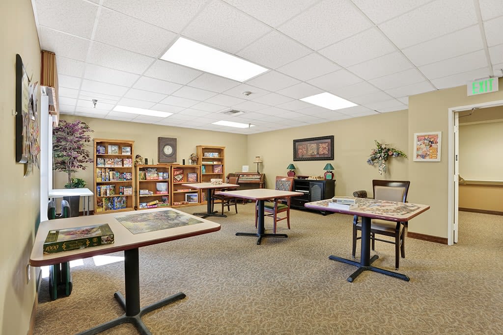 A quiet reading room with tables and bookshelves for study.