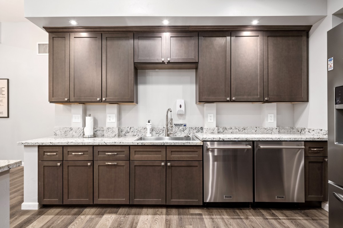 A modern kitchen with wooden cabinets and stainless steel appliances.