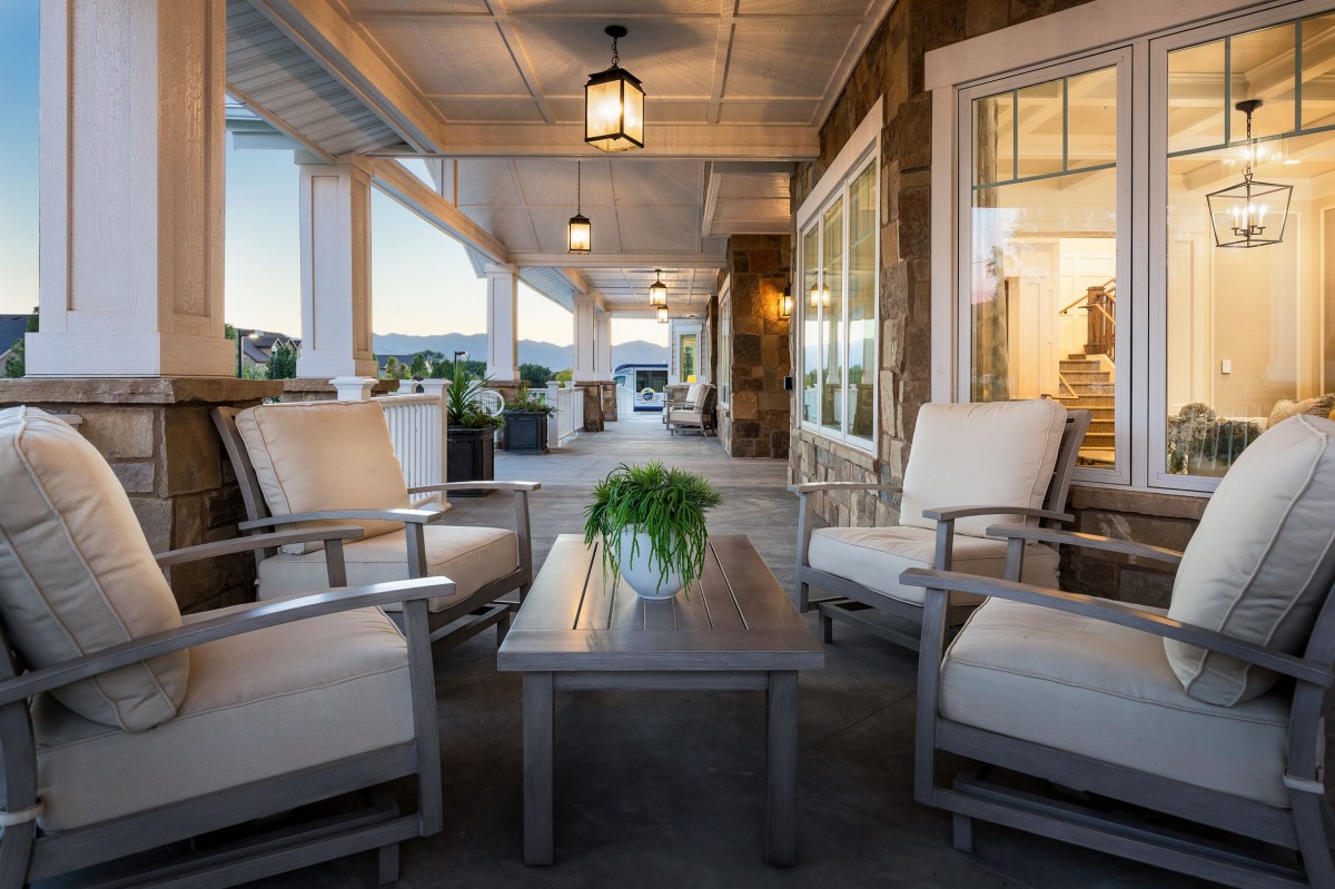 A cozy porch with comfortable seating arrangements and soft lighting for a relaxing evening.