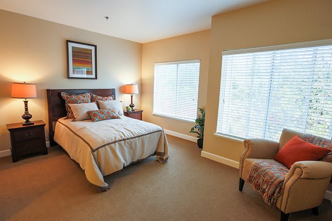 A cozy bedroom with modern decor and ample natural light.