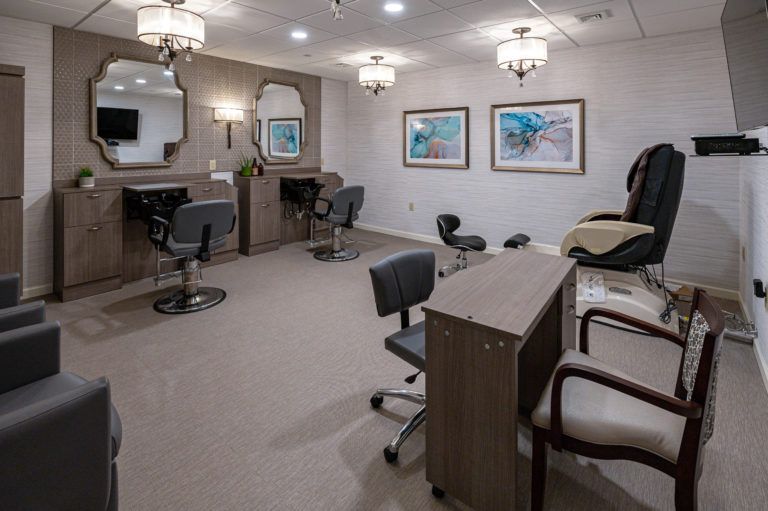 A modern beauty salon interior with stylish chairs, mirrors, and elegant lighting.