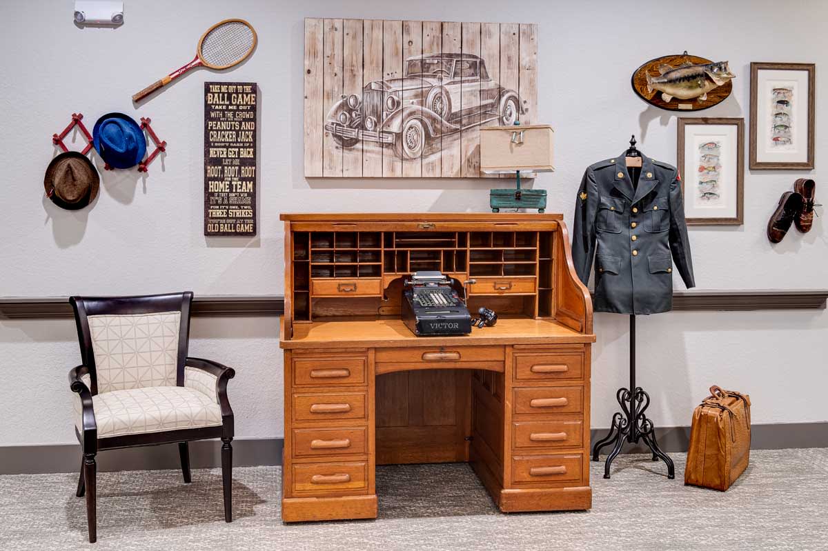A vintage office setup featuring an antique wooden desk, a rotary telephone, and nostalgic decor elements.