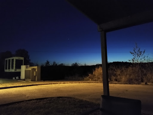 A serene night landscape transitioning into dusk, illuminated softly by ambient light.