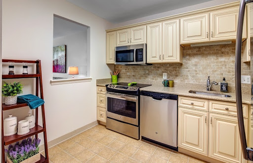 A modern kitchen featuring stainless steel appliances and light-colored cabinetry.
