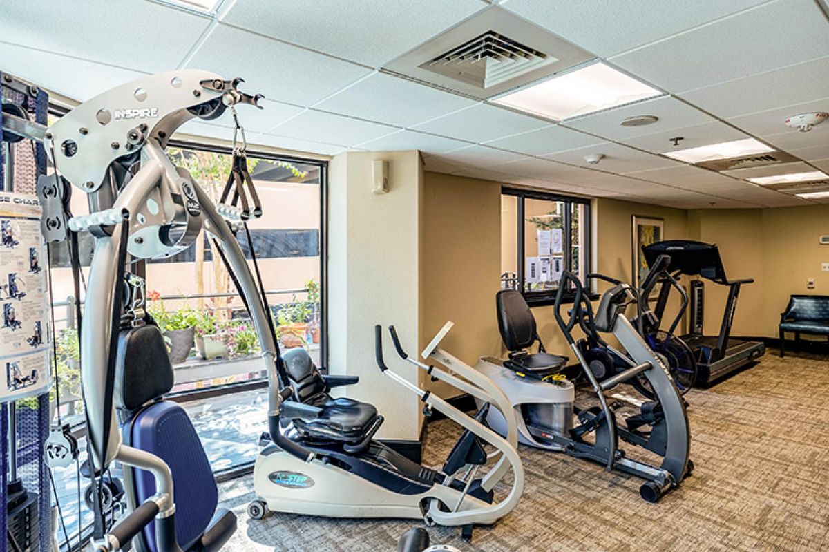 A well-equipped gym with various exercise machines.