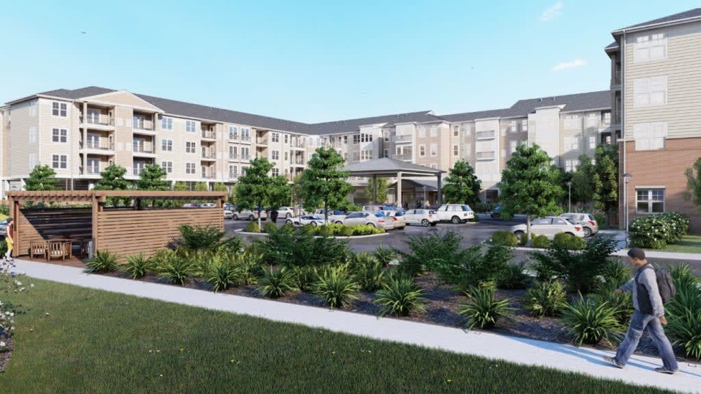 A modern apartment complex with landscaped gardens and greenery.