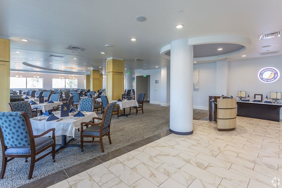 A modern restaurant dining area with neatly arranged tables and chairs.