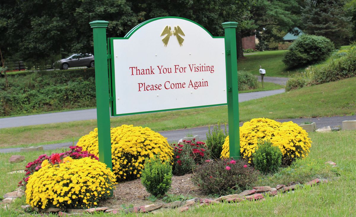 A sign in a garden area reads 'Thank You For Visiting, Please Come Again', surrounded by vibrant flowers.