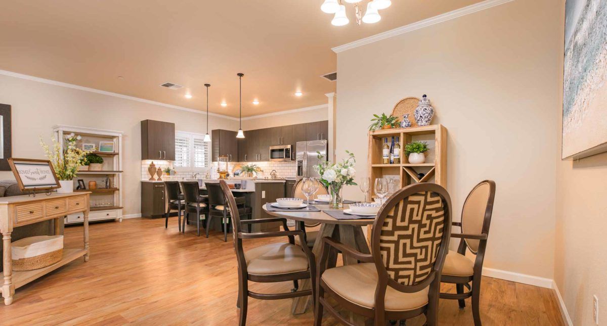 A spacious open-plan kitchen and dining area with modern decor and warm lighting.