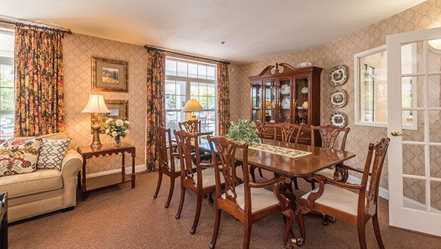 A traditional dining room with elegant furniture and decor.