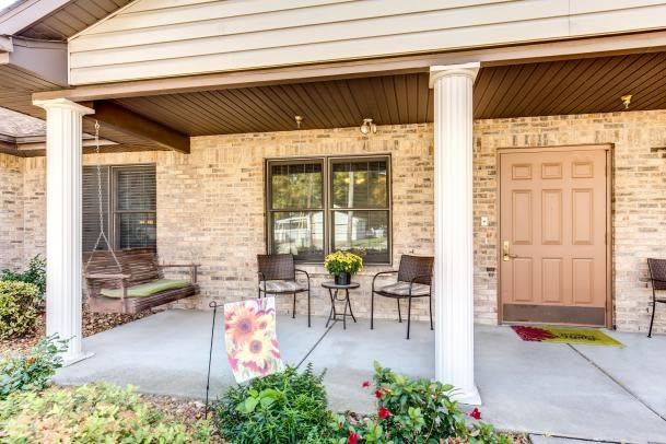 A cozy front porch with a swing and seating area.