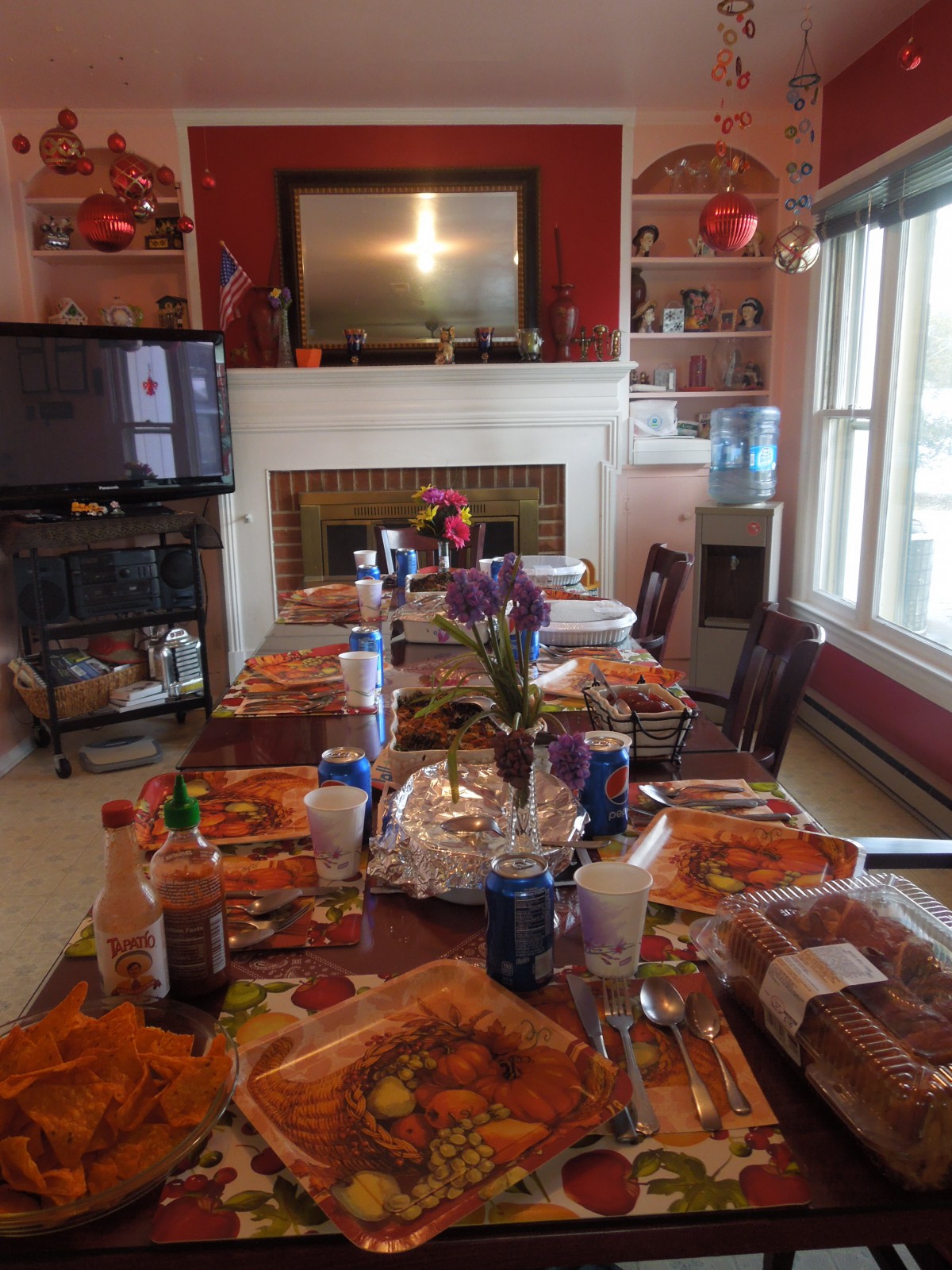 A dining table is set for a meal in a warmly decorated room.
