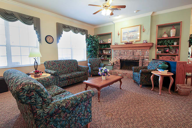 A cozy living room with comfortable seating and a fireplace.