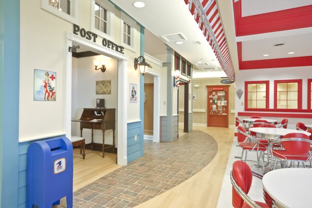 A vintage-themed indoor setting featuring a post office and a retro cafe.