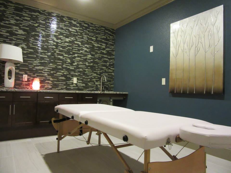 A tranquil massage room with a therapy table and soothing decor.