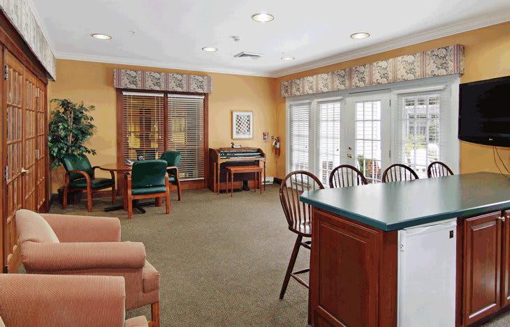 A cozy living room with comfortable seating and large windows letting in natural light.
