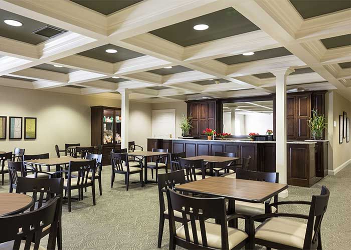 Spacious dining area with multiple tables and chairs, featuring elegant interior design.