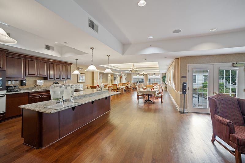 A spacious kitchen and dining area with modern amenities and wood flooring.