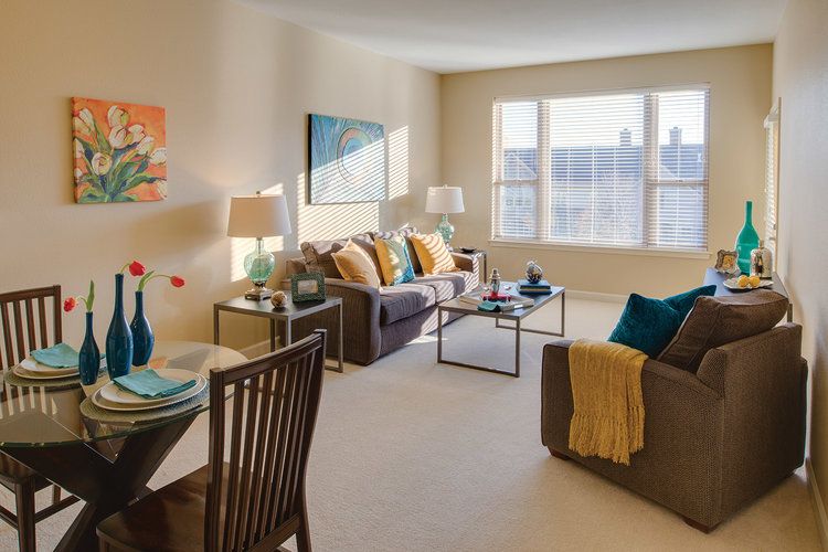 A cozy, modern living room with stylish decor and ample natural light.