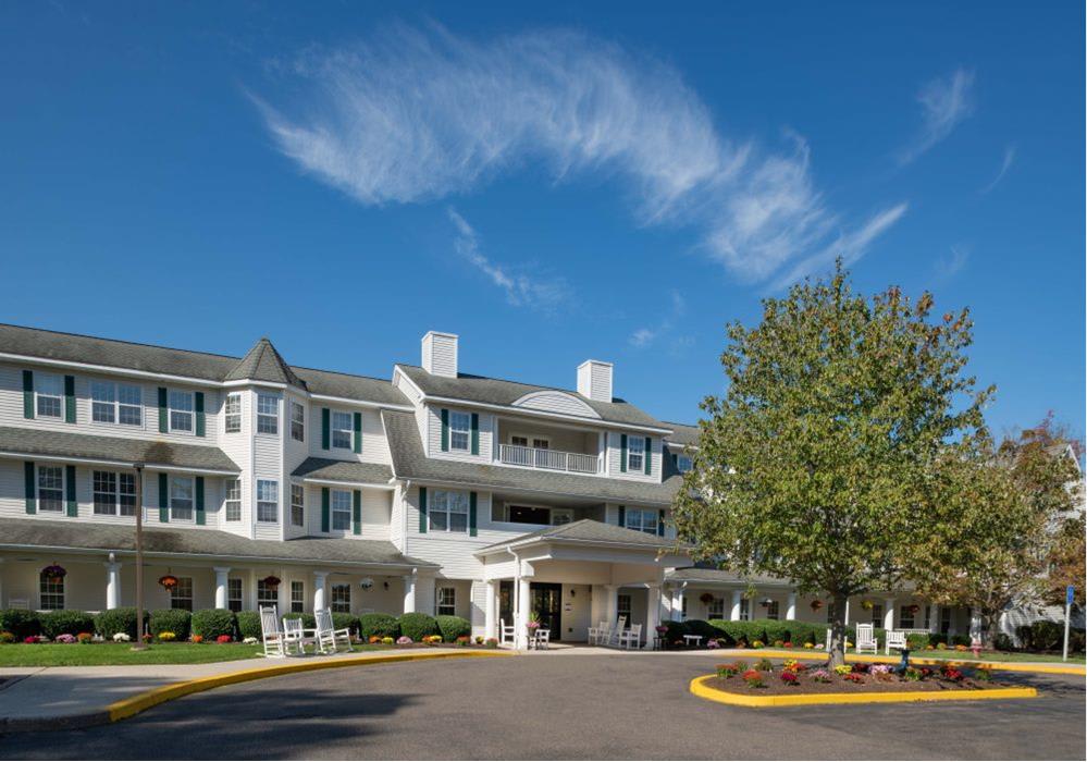A charming hotel with a classic architectural style under a clear blue sky.