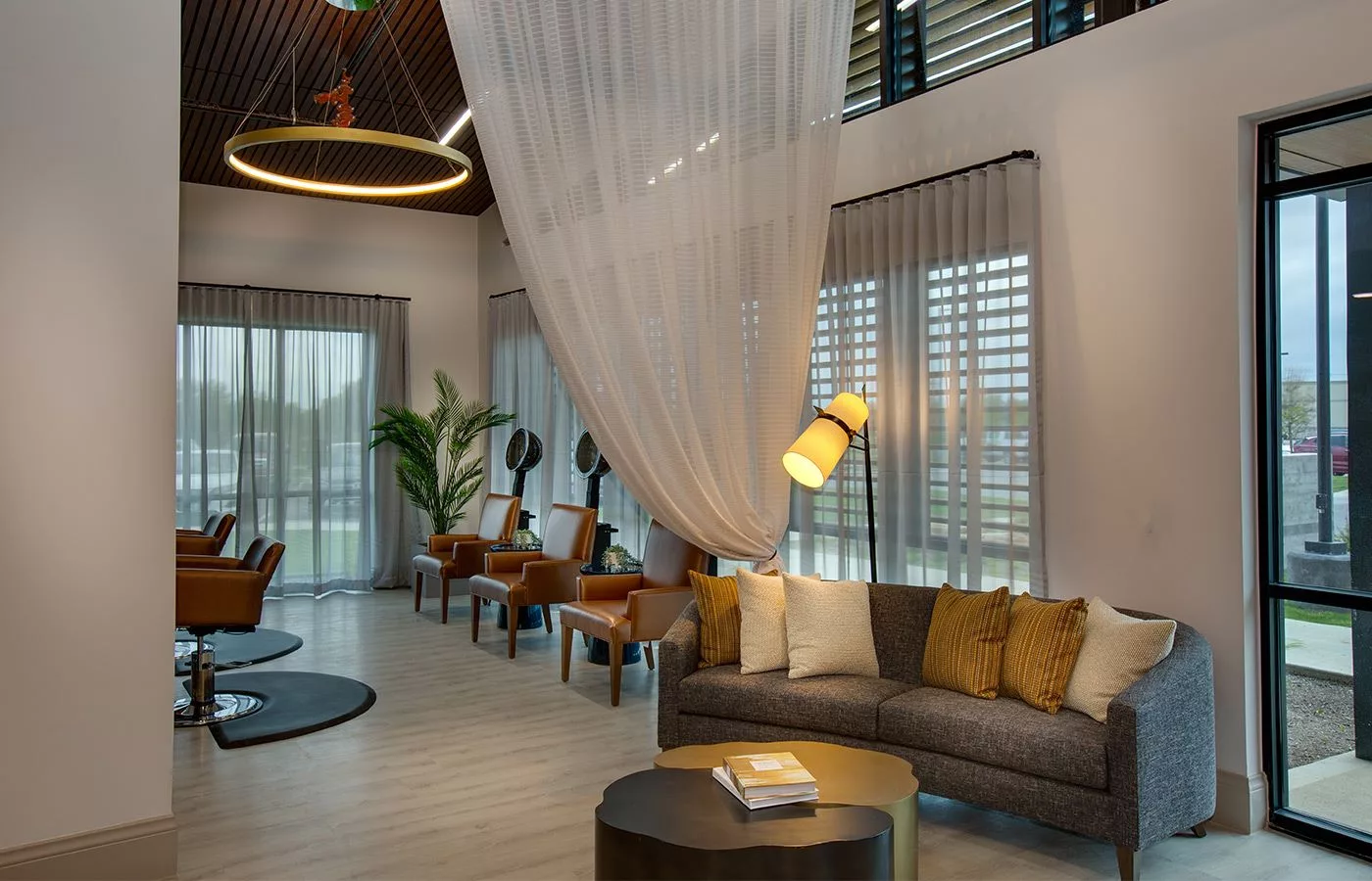 A modern and spacious lobby with elegant seating and decorative lighting.