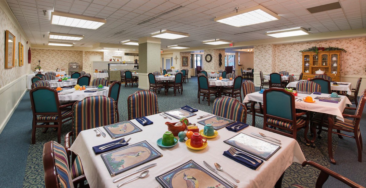 A well-set dining area with tables and chairs, ready for service in a restaurant or banquet setting.