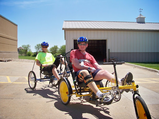 Two individuals enjoying a day of adaptive cycling on recumbent bikes.