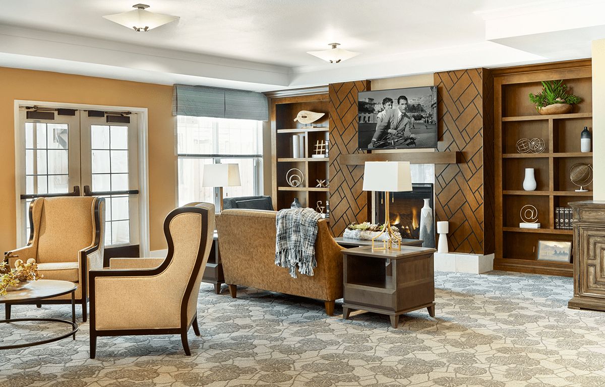 A cozy and well-decorated living room with comfortable seating, a television, and a bookshelf.