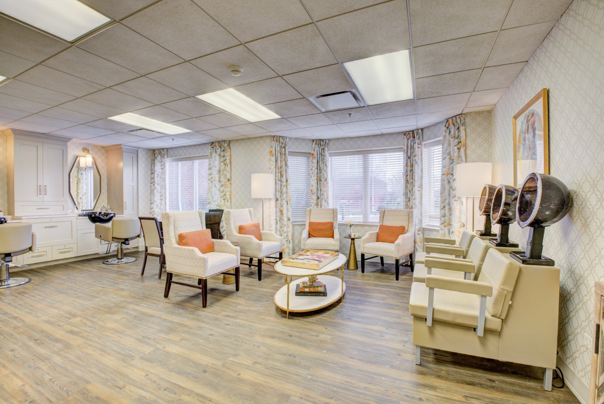 A modern and brightly lit waiting room with comfortable seating and large windows.