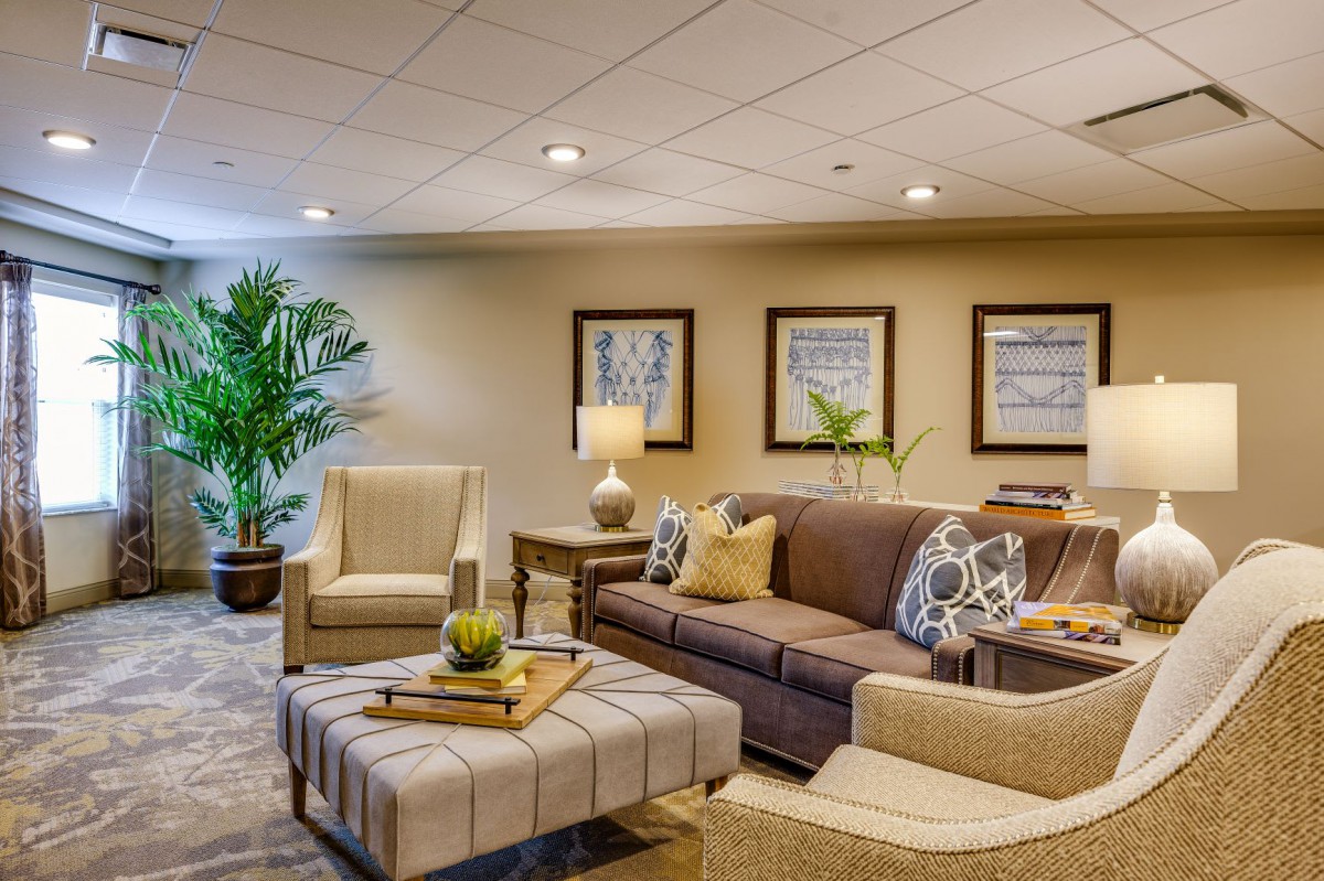 A cozy and well-decorated living room with comfortable seating and warm lighting.