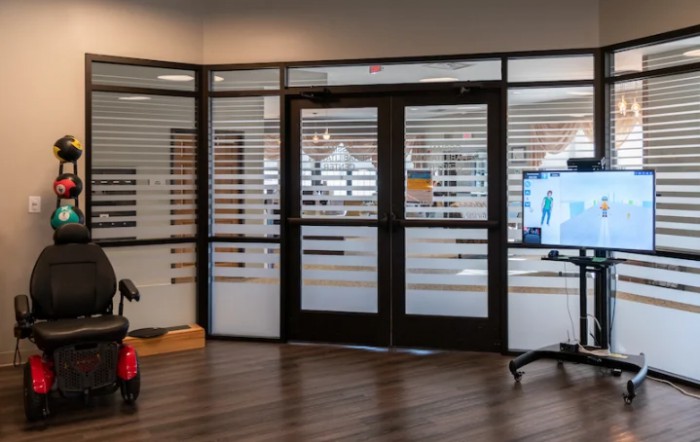 A modern office entrance with glass doors and sleek interior design.