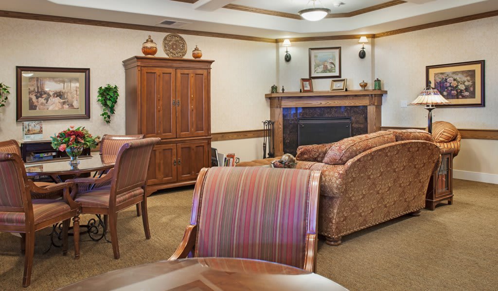 Cozy living room with wooden furniture and a fireplace.