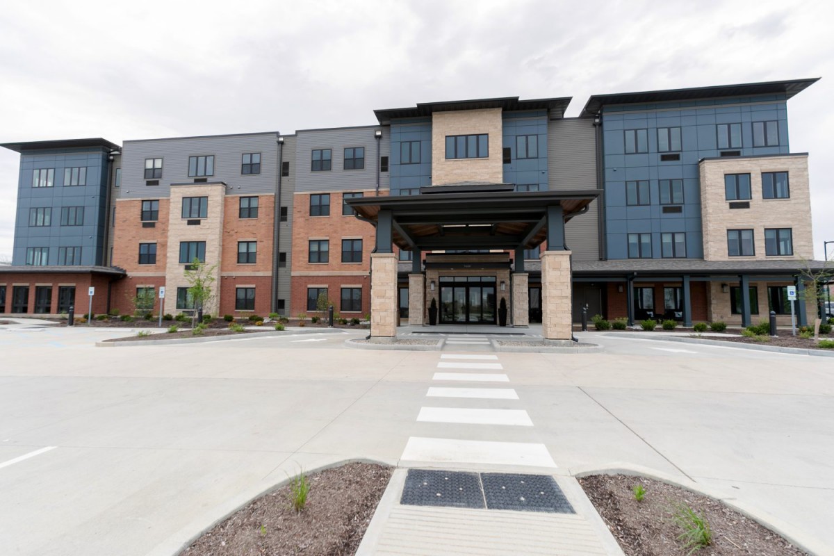 A modern commercial building with a prominent entryway and multi-story design.