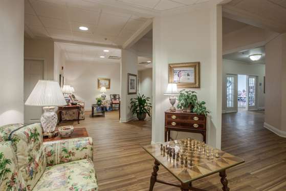 A cozy living room with a chess board on the table and comfortable seating.