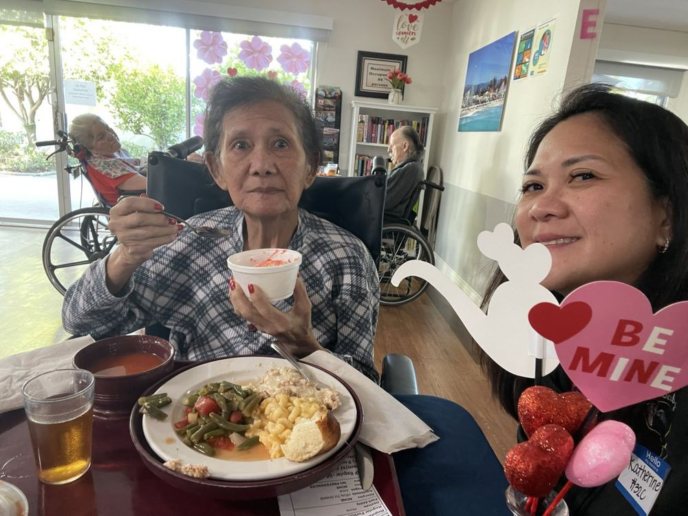 Two people enjoying a meal together indoors, suggesting a celebration.