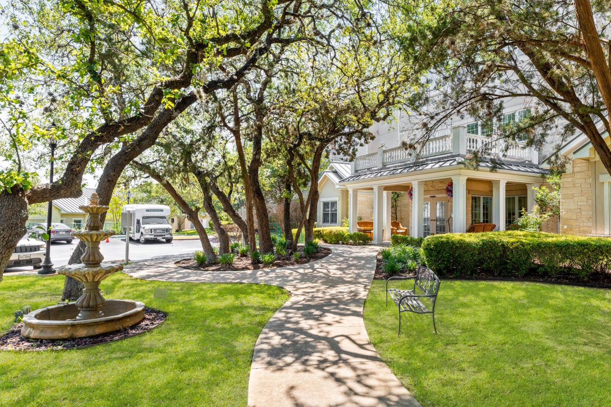 A picturesque house with a winding pathway and lush garden.