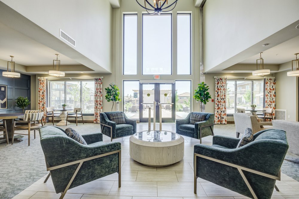 A spacious and modern lobby with comfortable seating, large windows allowing natural light, and elegant decor.
