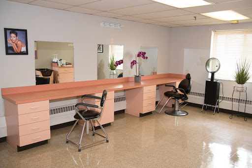 A well-organized beauty salon with multiple styling stations and mirrors.