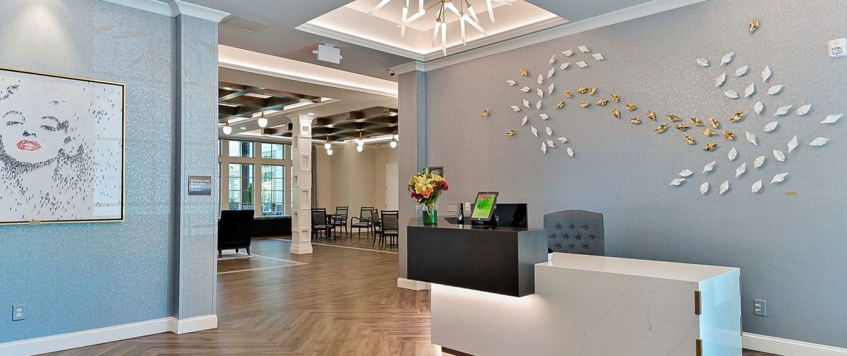 A modern reception area with elegant decor and lighting, featuring a welcoming lobby space.
